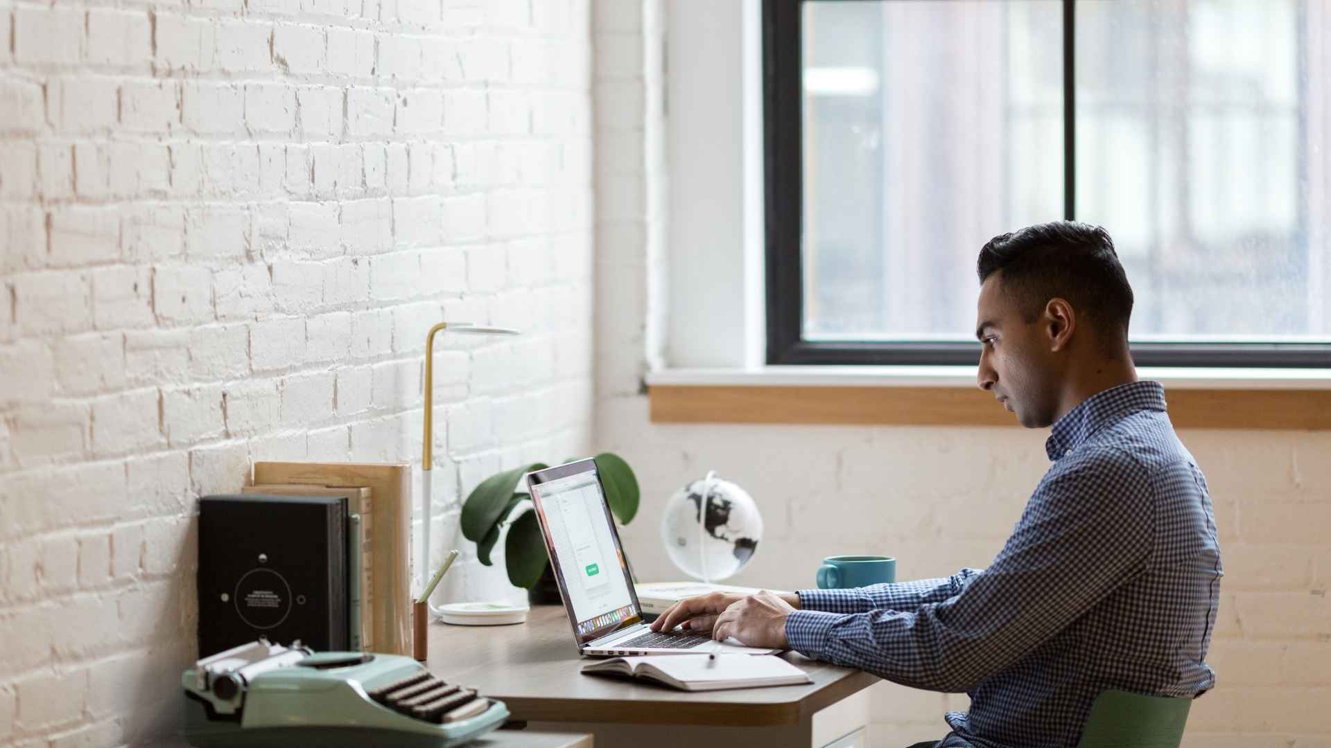 man works from home at office